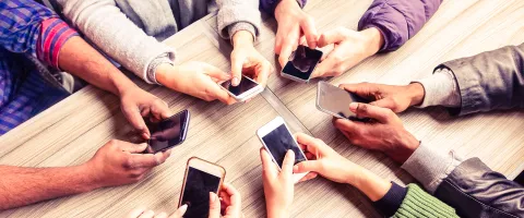 Group of people on their mobile phone